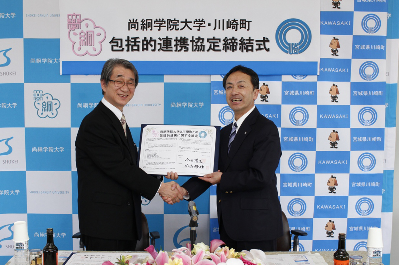 握手をする合田学長（左）と小山町長（右）